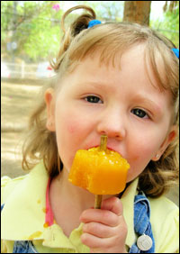 girl eating orange ice cream